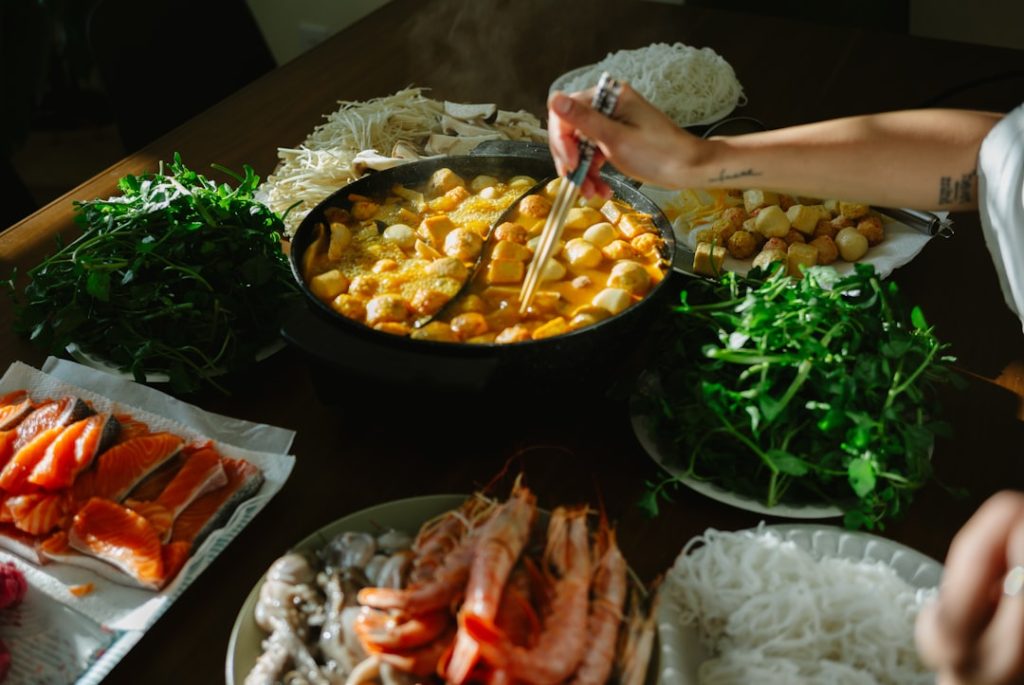 table-filled-with-ingredients-for-hot-pot-meal-mbqha6e6fs
